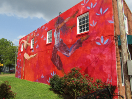 Two dancers portrayed on mural located behind Beer Girl