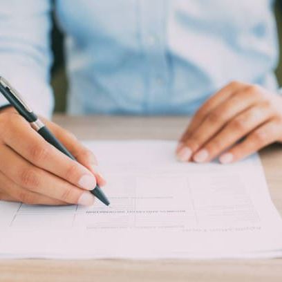 Photo of hands filling out application